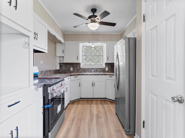 1705 Spruce St, Bay City, TX 77414 - kitchen featuring appliances with stainless steel finishes, crown molding, a ceiling fan, white cabinetry, and backsplash