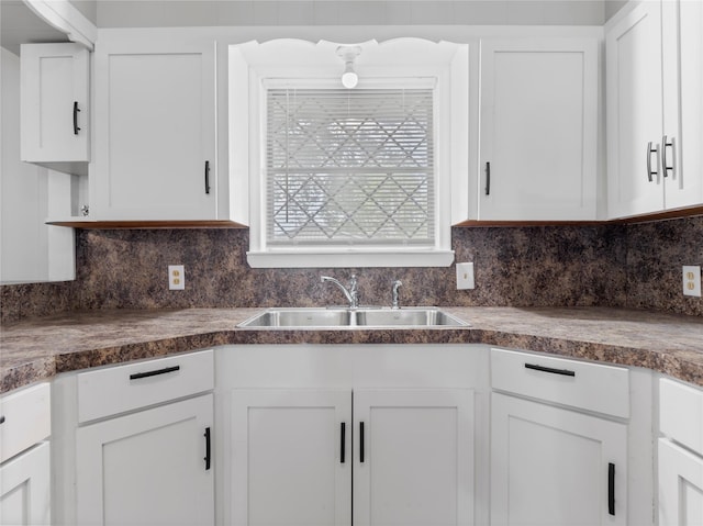 1705 Spruce St, Bay City, TX 77414 - kitchen featuring white cabinets, tasteful backsplash, and dark countertops