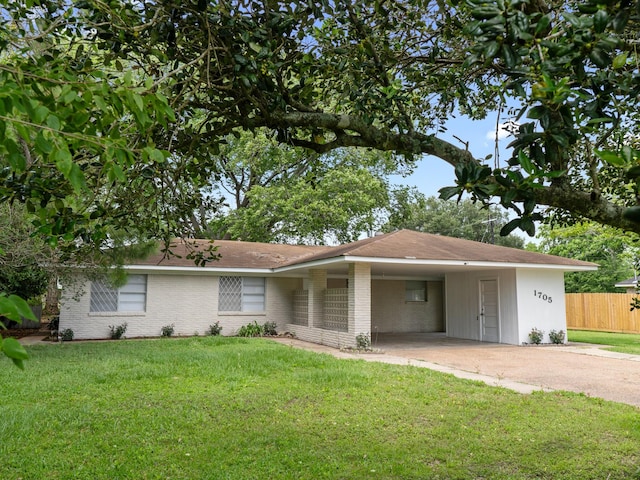 1705 Spruce St, Bay City, TX 77414 - view of front of house featuring driveway, a carport, and brick siding