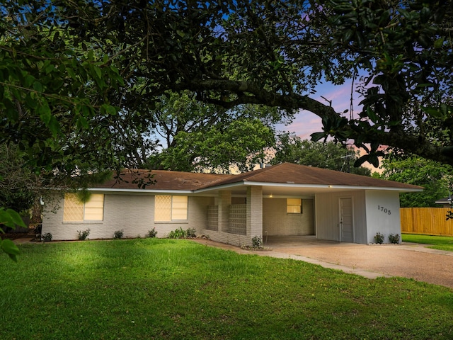 1705 Spruce St, Bay City, TX 77414 - view of front facade with concrete driveway, an attached carport, and brick siding