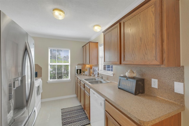 2222 3rd St, Rosenberg, TX 77471 - kitchen with stainless steel fridge with ice dispenser, white dishwasher, decorative backsplash, light countertops, and light tile patterned flooring