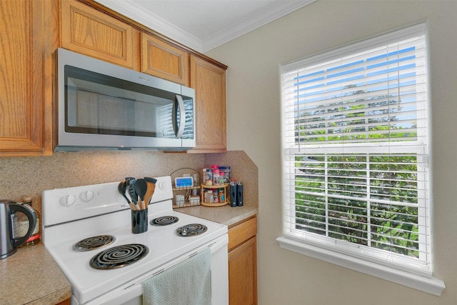 2222 3rd St, Rosenberg, TX 77471 - kitchen with stainless steel microwave, white electric stove, ornamental molding, tasteful backsplash, and light countertops
