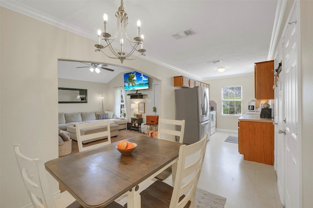 2222 3rd St, Rosenberg, TX 77471 - dining space with ornamental molding, a ceiling fan, and a chandelier
