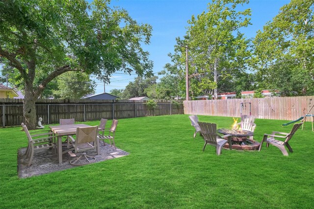 2222 3rd St, Rosenberg, TX 77471 - fenced backyard featuring an outdoor fire pit and a patio