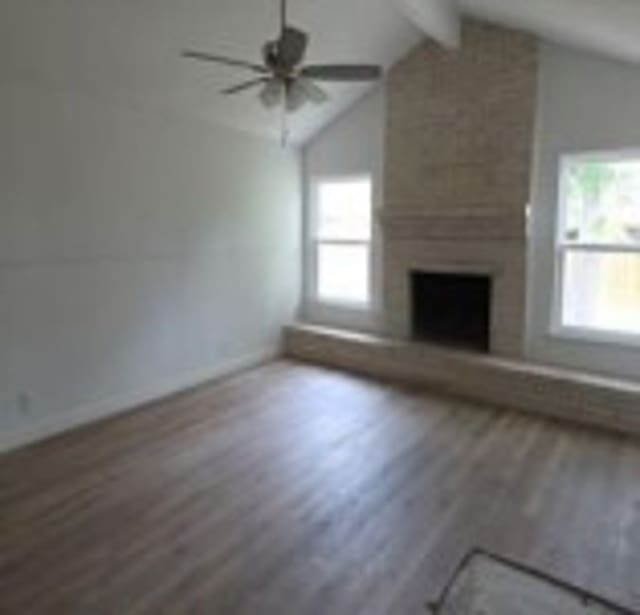 6402 Green Top Dr, San Antonio, TX 78233 - unfurnished living room featuring wood finished floors, healthy amount of natural light, ceiling fan, and a large fireplace
