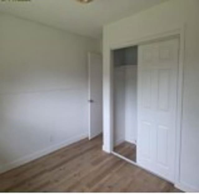6402 Green Top Dr, San Antonio, TX 78233 - unfurnished bedroom featuring wood finished floors and a closet