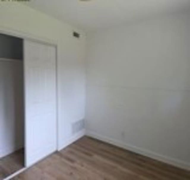 6402 Green Top Dr, San Antonio, TX 78233 - unfurnished bedroom featuring wood finished floors and a closet
