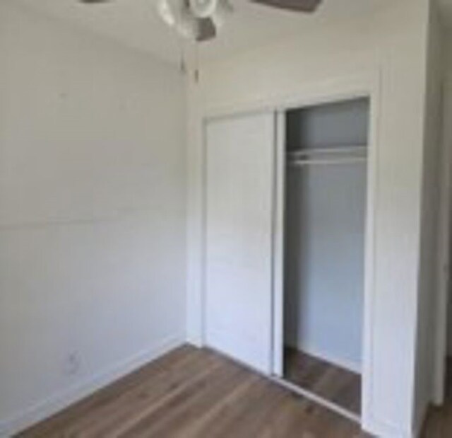 6402 Green Top Dr, San Antonio, TX 78233 - unfurnished bedroom with dark wood-type flooring, a closet, and ceiling fan