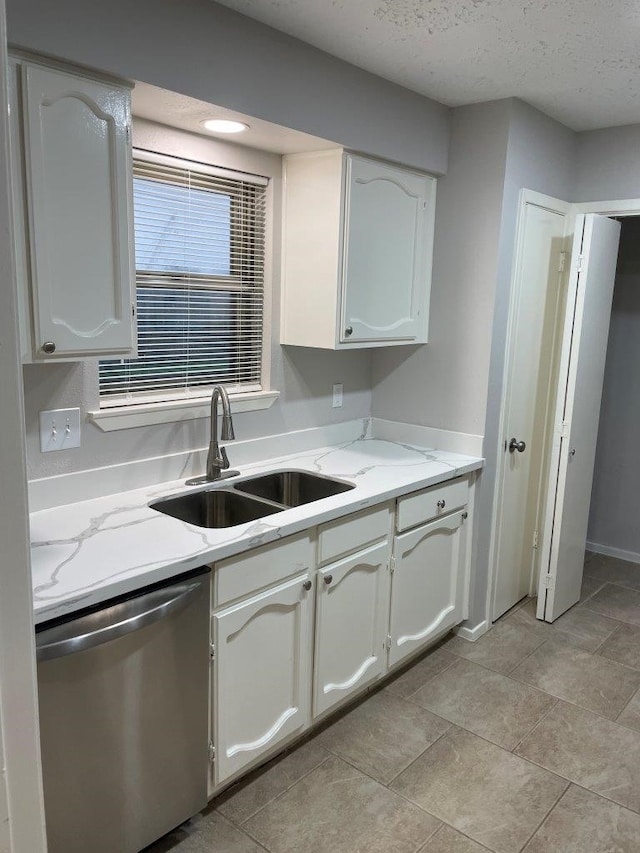 14207 Montaigne Dr, Cypress, TX 77429 - kitchen with stainless steel dishwasher, white cabinetry, and light stone countertops