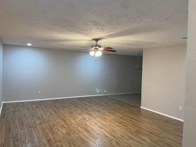 14207 Montaigne Dr, Cypress, TX 77429 - spare room featuring a ceiling fan, wood finished floors, and a textured ceiling