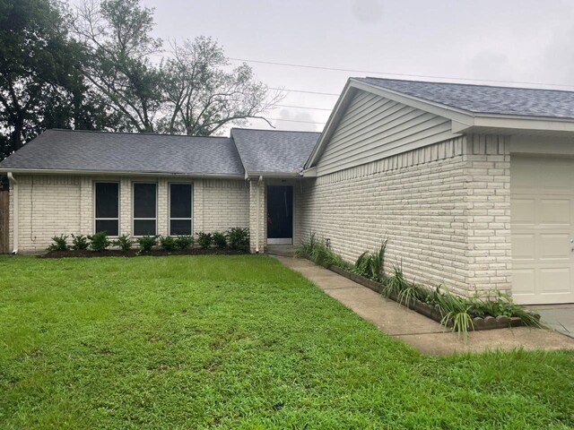 14207 Montaigne Dr, Cypress, TX 77429 - view of front facade featuring a garage, brick siding, and roof with shingles