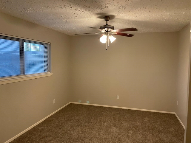 14207 Montaigne Dr, Cypress, TX 77429 - empty room with dark colored carpet, ceiling fan, and a textured ceiling