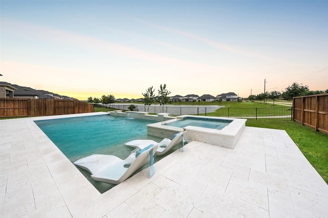 400 Horizon Light Ln, Katy, TX 77493 - pool at dusk with a pool with connected hot tub, a patio, and a fenced backyard