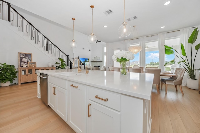 400 Horizon Light Ln, Katy, TX 77493 - kitchen with recessed lighting, open floor plan, dishwasher, light wood finished floors, and white cabinets