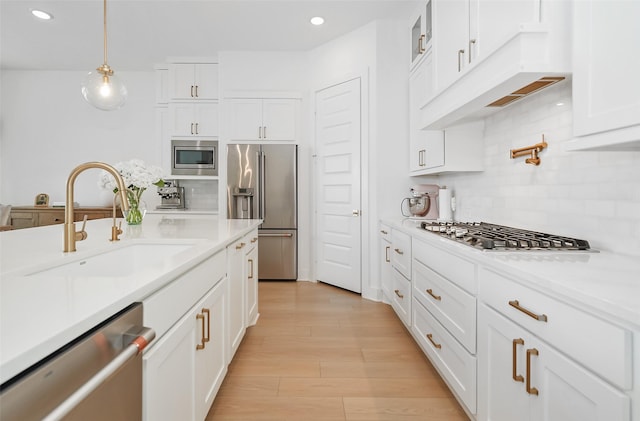 400 Horizon Light Ln, Katy, TX 77493 - kitchen featuring appliances with stainless steel finishes, white cabinetry, decorative backsplash, light countertops, and recessed lighting
