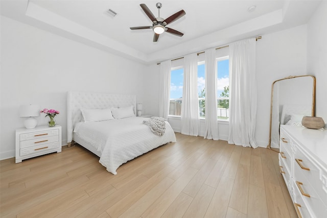 400 Horizon Light Ln, Katy, TX 77493 - bedroom featuring a tray ceiling, light wood-type flooring, and a ceiling fan