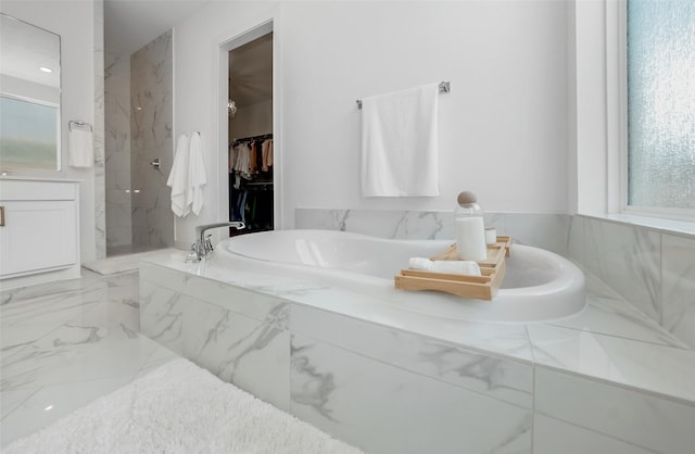 400 Horizon Light Ln, Katy, TX 77493 - bathroom with healthy amount of natural light, a tub with marble appearance, a marble finish shower, and marble tiled flooring