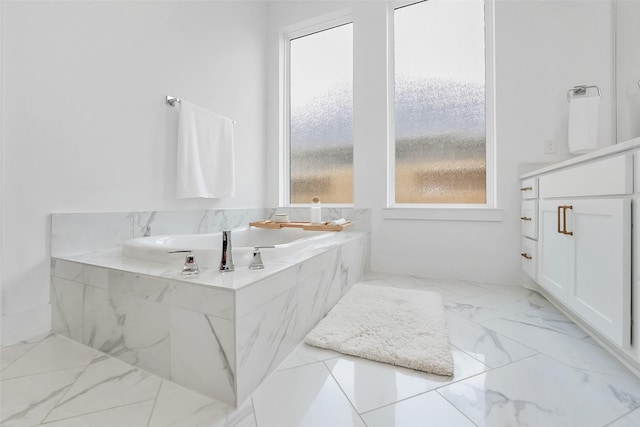 400 Horizon Light Ln, Katy, TX 77493 - bathroom featuring marble finish flooring, vanity, and a tub with marble appearance