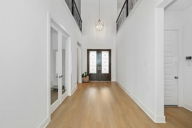 400 Horizon Light Ln, Katy, TX 77493 - foyer entrance featuring french doors, a chandelier, light wood-style floors, and a towering ceiling