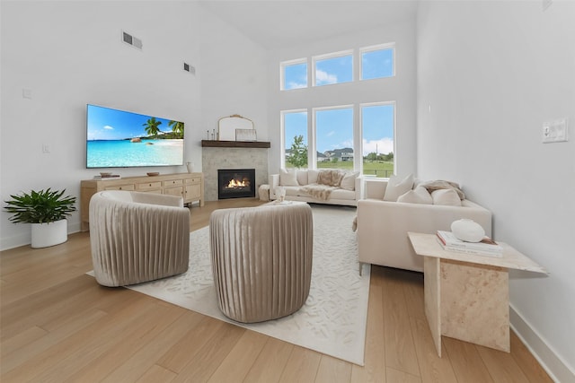 400 Horizon Light Ln, Katy, TX 77493 - living room with wood finished floors, a glass covered fireplace, and a high ceiling