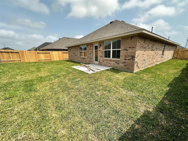 4301 Fenwick Rd, Texas City, TX 77591 - rear view of property with brick siding, a fenced backyard, a patio, and roof with shingles