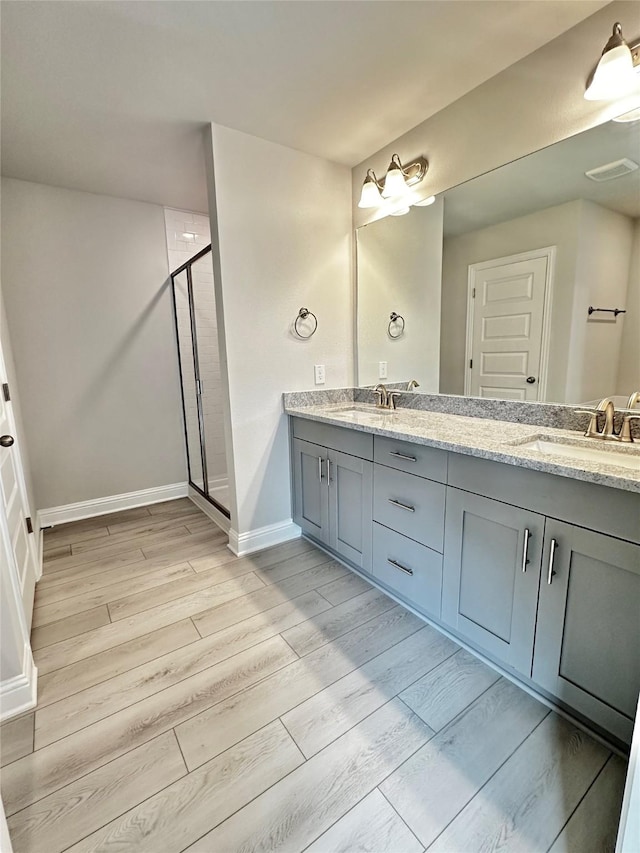 4301 Fenwick Rd, Texas City, TX 77591 - full bathroom featuring double vanity, wood finished floors, and a shower stall