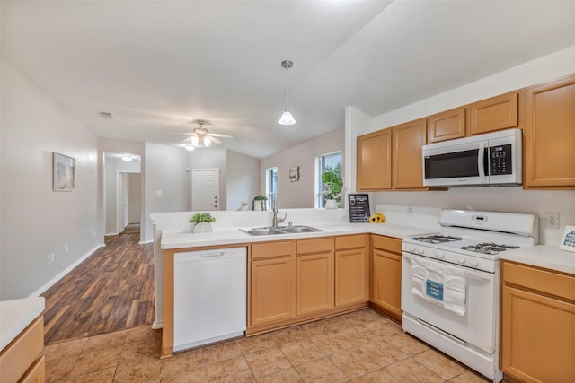 20806 Dewberry Creek Ln, Katy, TX 77449 - kitchen with white appliances, a peninsula, light countertops, a ceiling fan, and pendant lighting