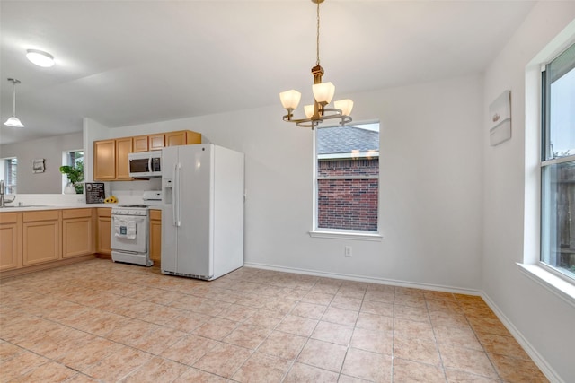 20806 Dewberry Creek Ln, Katy, TX 77449 - kitchen featuring white appliances, a chandelier, light countertops, and pendant lighting