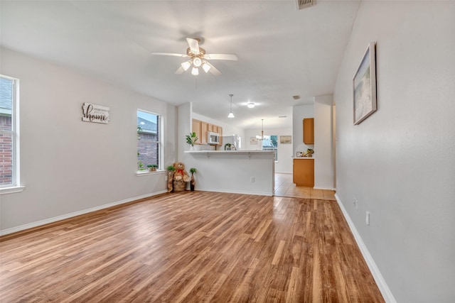20806 Dewberry Creek Ln, Katy, TX 77449 - unfurnished living room with light wood-style floors and ceiling fan