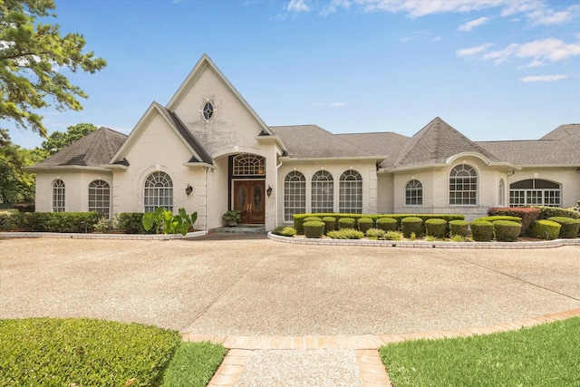 16919 Storybrook Forest Dr, Tomball, TX 77377 - french country inspired facade with brick siding and roof with shingles