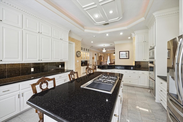 16919 Storybrook Forest Dr, Tomball, TX 77377 - kitchen featuring appliances with stainless steel finishes, recessed lighting, ornamental molding, a kitchen island, and backsplash
