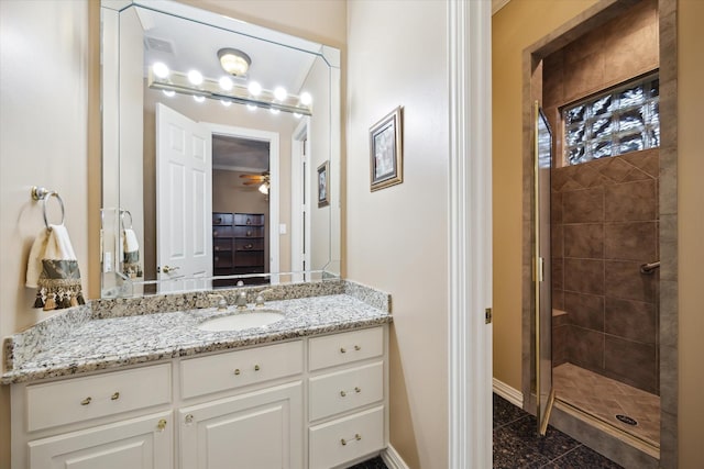 16919 Storybrook Forest Dr, Tomball, TX 77377 - bathroom featuring a tile shower, vanity, and ceiling fan