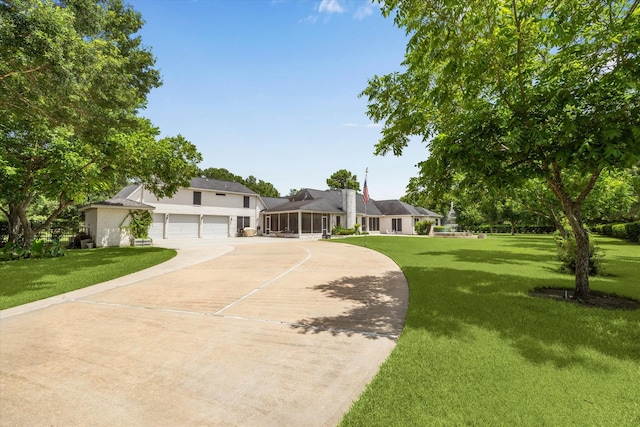 16919 Storybrook Forest Dr, Tomball, TX 77377 - view of front of home with concrete driveway, a front yard, stucco siding, an attached garage, and a sunroom