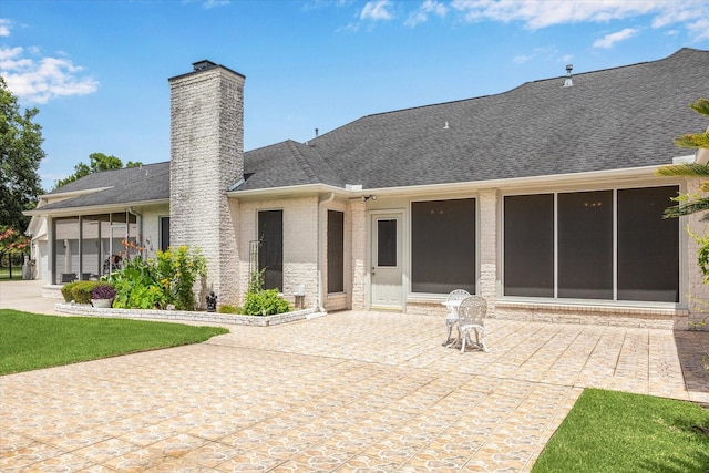 16919 Storybrook Forest Dr, Tomball, TX 77377 - back of property with a patio area, a chimney, roof with shingles, brick siding, and stone siding