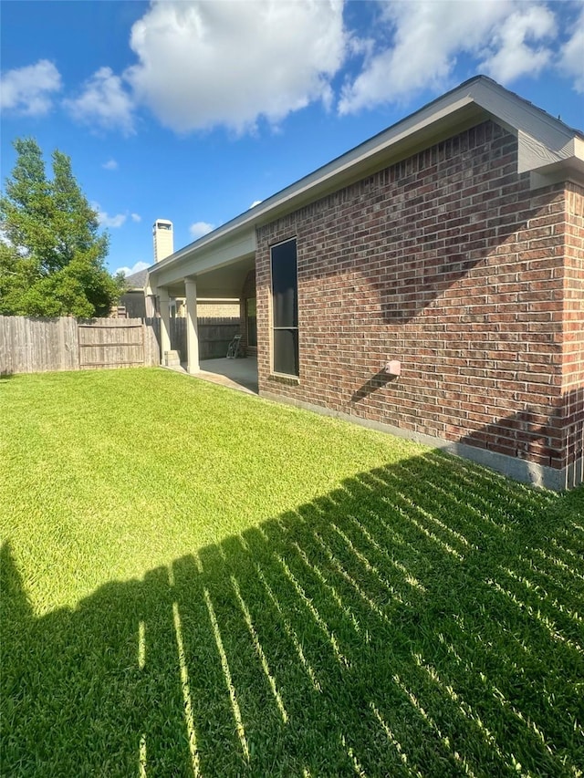 29018 Pinnacle Ridge Dr, Katy, TX 77494 - back of house featuring brick siding, a patio area, and a chimney