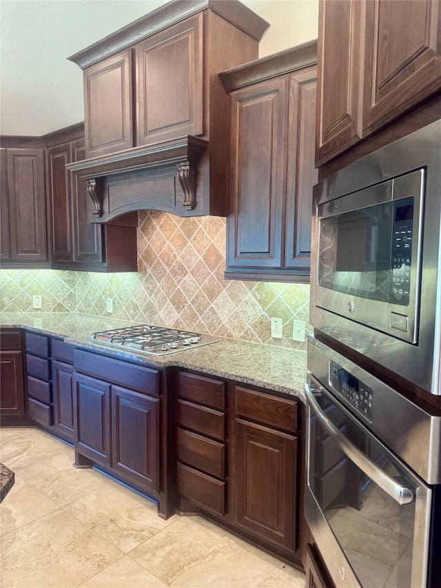 29018 Pinnacle Ridge Dr, Katy, TX 77494 - kitchen featuring appliances with stainless steel finishes, light stone countertops, and tasteful backsplash