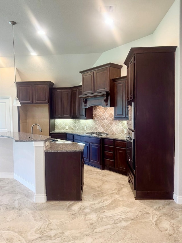 29018 Pinnacle Ridge Dr, Katy, TX 77494 - kitchen featuring stainless steel appliances, lofted ceiling, stone counters, decorative backsplash, and light marble finish floors