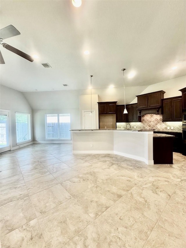 29018 Pinnacle Ridge Dr, Katy, TX 77494 - kitchen with vaulted ceiling, open floor plan, decorative backsplash, ceiling fan, and dark brown cabinets