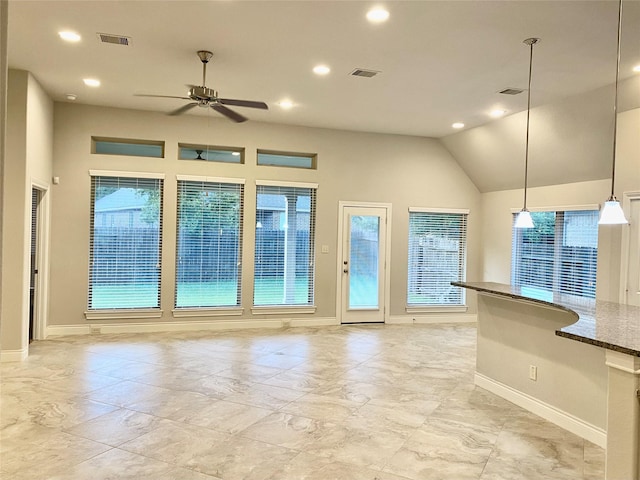 29018 Pinnacle Ridge Dr, Katy, TX 77494 - kitchen with ceiling fan, recessed lighting, lofted ceiling, decorative light fixtures, and dark stone counters