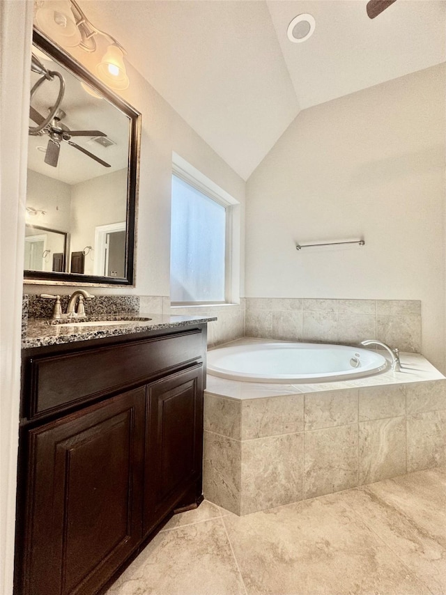 29018 Pinnacle Ridge Dr, Katy, TX 77494 - bathroom with a ceiling fan, vanity, a bath, tile patterned floors, and vaulted ceiling