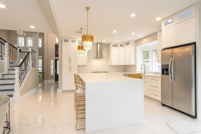 5515 E Terrace Gable Cir, Katy, TX 77494 - kitchen with stainless steel refrigerator with ice dispenser, wall chimney range hood, a chandelier, a center island, and recessed lighting