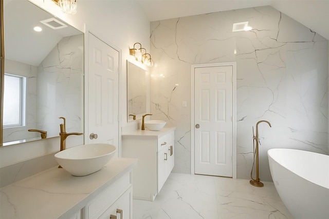 5515 E Terrace Gable Cir, Katy, TX 77494 - bathroom with stone wall, vanity, marble tiled floors, a freestanding bath, and vaulted ceiling