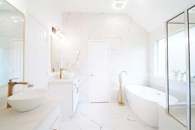 5515 E Terrace Gable Cir, Katy, TX 77494 - full bath with two vanities, marble tiled flooring, a freestanding tub, and lofted ceiling
