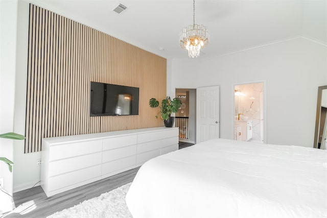 5515 E Terrace Gable Cir, Katy, TX 77494 - bedroom featuring a chandelier, wood finished floors, and ensuite bath