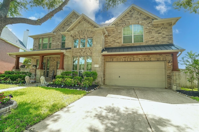 5515 E Terrace Gable Cir, Katy, TX 77494 - traditional-style home featuring a garage, driveway, a standing seam roof, stone siding, and a front yard
