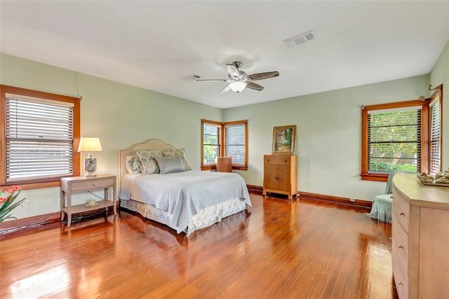 4316 Caduceus Pl, Galveston, TX 77550 - bedroom with multiple windows, wood finished floors, and ceiling fan