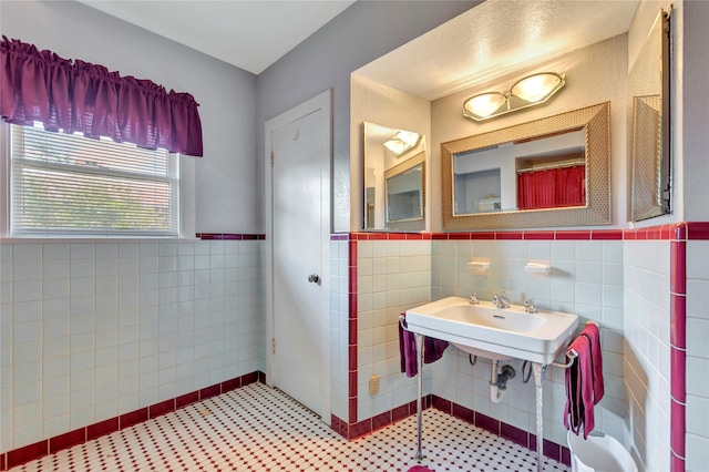 4316 Caduceus Pl, Galveston, TX 77550 - bathroom featuring tile walls and a wainscoted wall