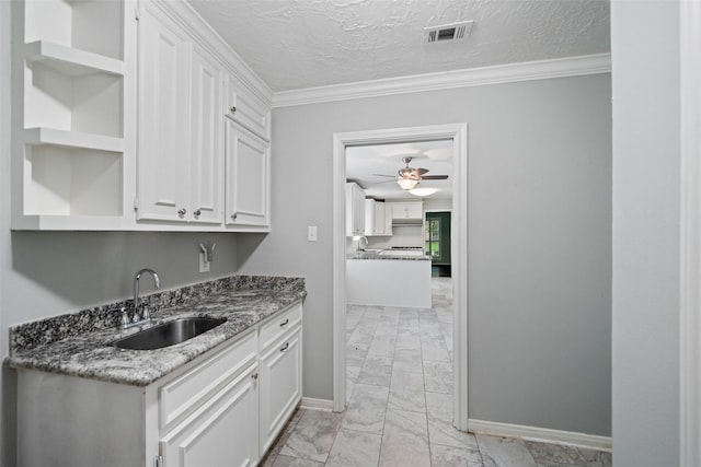 11607 Knobcrest Dr, Houston, TX 77070 - kitchen with light marble finish flooring, open shelves, white cabinets, ornamental molding, and ceiling fan