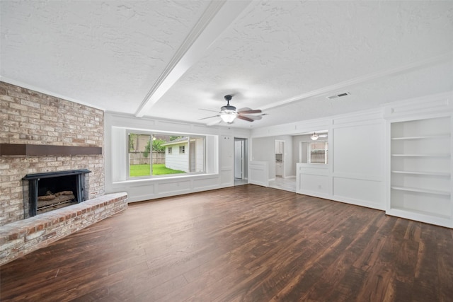 11607 Knobcrest Dr, Houston, TX 77070 - unfurnished living room with a textured ceiling, wood finished floors, a fireplace, ceiling fan, and built in shelves