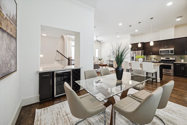 1124 W 24th St Unit B, Houston, TX 77008 - dining area featuring wine cooler, dark wood-style flooring, stairway, arched walkways, and crown molding